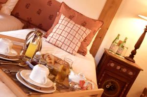 a bed with a tray of food on a table at Chalet d'Adrien in Verbier