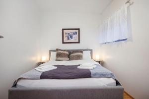 a bedroom with a large bed with two lamps at Cozy 3 bedroom house near the Blue lagoon in Njarðvík