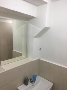 a white bathroom with a mirror and a sink at City Center AP 2 in Košice