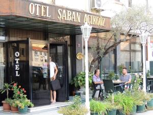 a couple of people sitting outside of a restaurant at Saban Acikgoz Hotel in Edirne