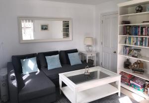 a living room with a couch and a book shelf at Sea Lodge Holiday Home in Bantry