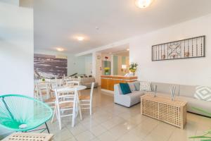 a living room with a couch and a table and chairs at Residence Baltic in Cattolica