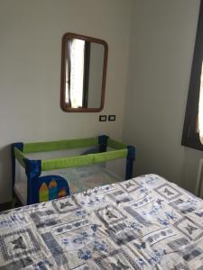 a bedroom with a bed and a mirror at Margherita Friendly house in Almè