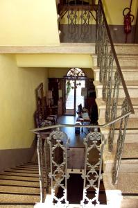 a staircase with a glass table in a room at Locanda Delle Mura Anna De Croy in Magliano in Toscana