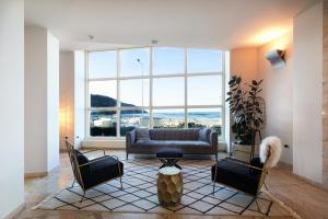 a living room with a couch and two chairs at Hotel Baia Flaminia in Pesaro