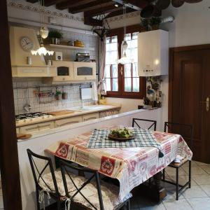 a kitchen with a table with a plate of food on it at La Corte in Venice