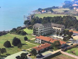 a large building on a hill next to the ocean at Gîte horizon mer et campagne in Pornic