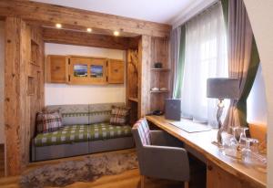a living room with a bed and a desk at Altstadt-Hotel Passau in Passau