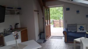 a kitchen with a door open to a patio at Ferienwohnung Kruppa Rerik in Rerik