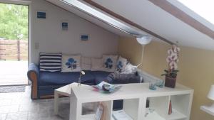 a living room with a couch and a table at Ferienwohnung Kruppa Rerik in Rerik