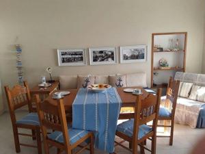 a dining room with a table and chairs and a couch at Kalymnos Beach House in Kalymnos