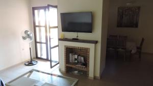 sala de estar con chimenea y TV por encima. en Hl 030 · HL030 luxurious villa, HDA golf resort en Fuente Alamo