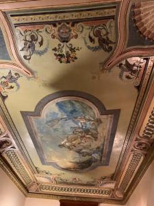 a ceiling with a painting on it at B&B Palazzo Melluso in Porto Empedocle