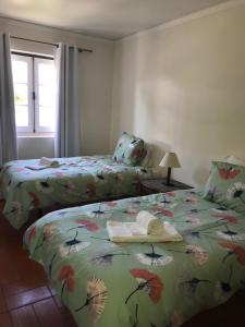 a bedroom with two beds and a window at Old Village in Vilamoura