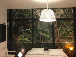 a bedroom with a bed and a large window at Gîte horizon mer et campagne in Pornic