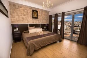 a bedroom with a bed with two stuffed animals on it at Hostal Casa Mercedes in Nerja