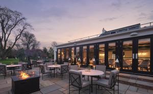 a patio with tables and chairs and a building at Monkey Island Estate - Small Luxury Hotels of the World in Windsor
