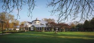 a large white house on a green lawn at Monkey Island Estate - Small Luxury Hotels of the World in Windsor