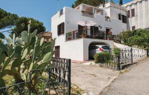a white house with a car parked in front of it at GAETA - Villa Fontania in Gaeta