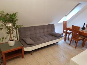 a couch sitting in a living room with a table at Casa Monte in Bovec