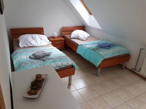 a small room with two beds and a table at Casa Monte in Bovec
