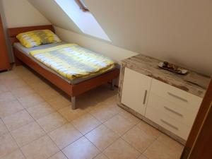 a small bedroom with a bed and a table at Casa Monte in Bovec