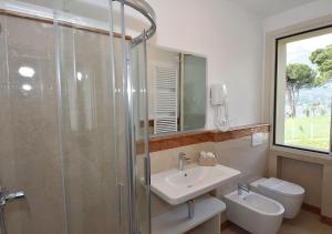 a bathroom with a shower and a sink and a toilet at Agriturismo Il Colle in Bellagio +113 photos