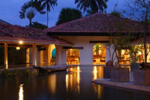 an exterior view of a house at night at Tangerine Beach Hotel in Kalutara
