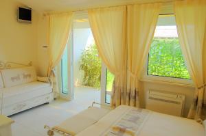 a bedroom with a bed and a large window at Hotel Budoni Beach in Budoni