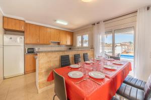 a dining room with a table and a kitchen at Holiday Home Olivia in L'Escala