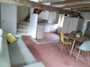 a living room with a couch and a table at Gite du Moulin de Balzac in Artannes-sur-Indre