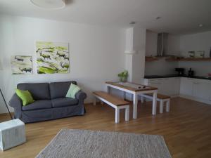 a living room with a couch and a table at Nassfeld Apartments - "Traditionell anders" in Sonnenalpe Nassfeld