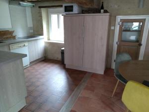 a kitchen with a microwave on top of a cabinet at Gite du Moulin de Balzac in Artannes-sur-Indre +3 photos