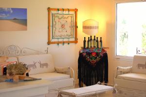 a living room with two couches and a table at Hotel Budoni Beach in Budoni