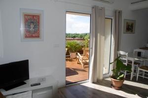 a living room with a sliding door to a patio at Gite DURANCE in Mallemort