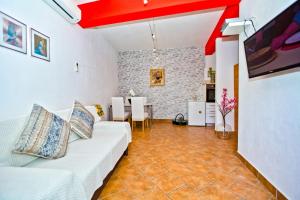 a living room with a white couch and a red ceiling at Apartments Bubalo in Hvar