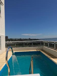 a swimming pool on the roof of a building at Departamento Rodrigo II in Posadas