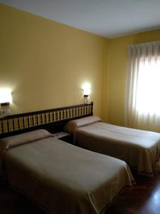 Postel nebo postele na pokoji v ubytování HOTEL CORINTO