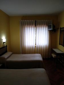 Postel nebo postele na pokoji v ubytování HOTEL CORINTO + 17 fotografií