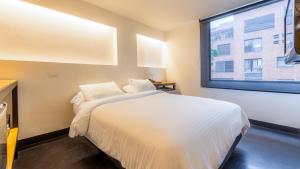 Ένα ή περισσότερα κρεβάτια σε δωμάτιο στο Hotel El Peñon by Bithotels