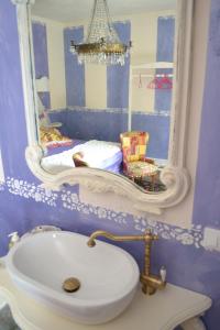 a bathroom with a sink and a mirror on the wall at La maison delle favole in Desenzano del Garda