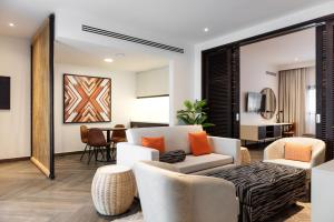 a living room with a couch and chairs at Emirates Park Resort in Abu Dhabi