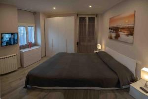 a bedroom with a large bed and a television at Portofino House in Camogli