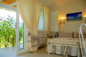 a bathroom with a large tub in a room at Hotel Budoni Beach in Budoni