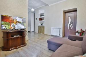 a living room with a couch and a tv at Apartment Anano in Kutaisi