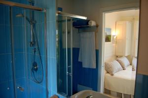 a bathroom with a shower and a sink at Hotel Budoni Beach in Budoni