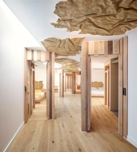 a room with several beds and a ceiling at Somiatruites in Igualada