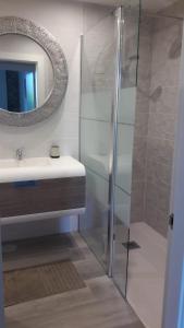 a bathroom with a sink and a mirror and a shower at Mirador del Cantábrico in Lastres