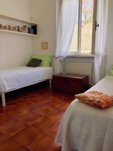 a room with two beds and a window at Casa con vista a Numana in Numana