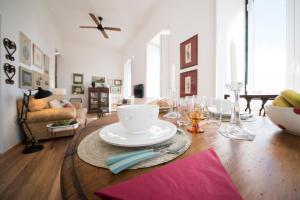 a living room with a table with plates and glasses at Light Lovers Apartment in Lisbon +35 photos